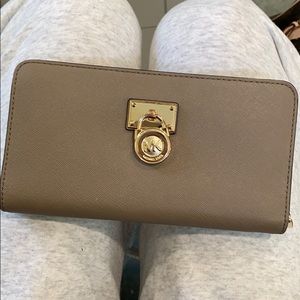 MK wallet with gold lock.